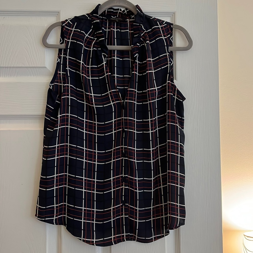 Plaid, sleeveless button down top.